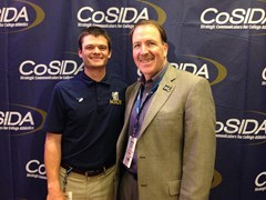 O’Kelly poses with SID Kelly Bird of Linfield College at the 2016 CoSIDA convention in Dallas. O’Kelly credits Bird with introducing him to the SID profession and teaching him the ropes as a Linfield student assistant.